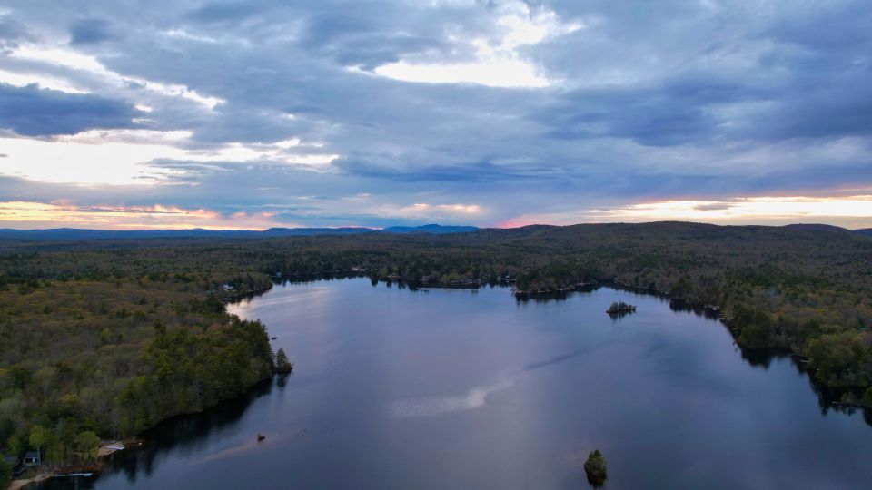 The lake, still, with hills behind